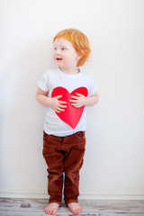 Red-haired boy with a valentine in his hands