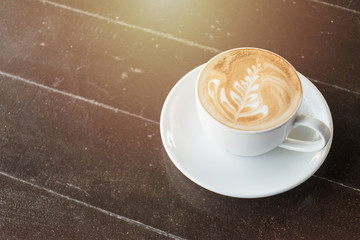 Cup of latte or cappuccino on the table in cafe
