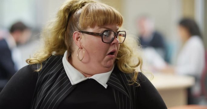 4K Portrait funny businesswoman looking at camera, reacting with exaggerated shock. Slow motion.