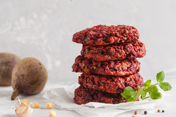 Beetroot vegan burgers with chickpea and herbs. Healthy vegetarian food concept. Copy space, light background.