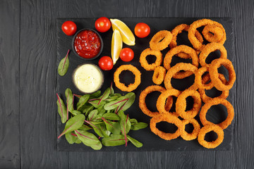 crispy onion rings with sauces and greens