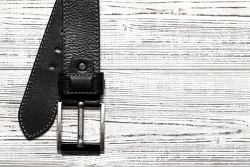 Leather belt with buckle on white background