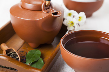 Ceramic teapot on a wooden tray.