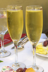 Two glasses of champagne on a festive table close up