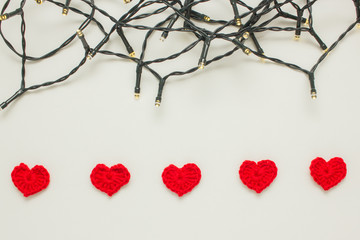 Red knitted hearts on garland