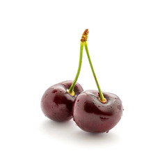 Photo of red cherries with tails and water drops isolated on white background