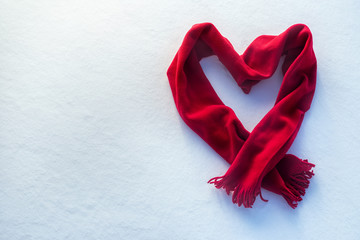 red scarf as heart on snow