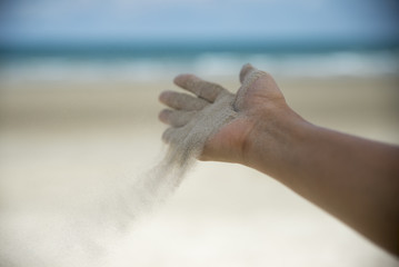  Release hand, Let it go and Freedom concept. Hand let go of woman release sand on beautiful sea...