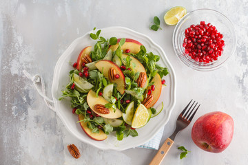 Light green apple pecan pomegranate salad. Vegan Healthy Food Concept. Top view, copy space
