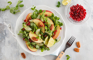 Light green apple pecan pomegranate salad. Vegan Healthy Food Concept. Top view, copy space