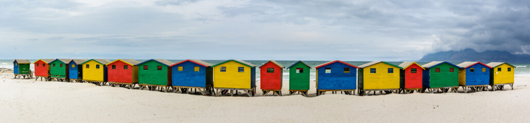 Ultra wide panorama of the colourful beach houses on Muizenberg beach - a popular tourist attraction near Cape Town, South Africa