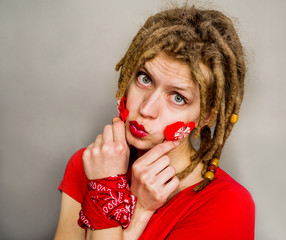 pretty woman with dreadlocks with a origami red heart, for Valentine's day