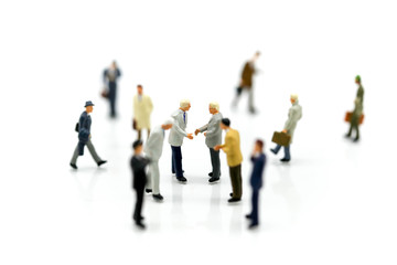 Miniature people : Businessmans make handshaking agreement with  the big group of the small business