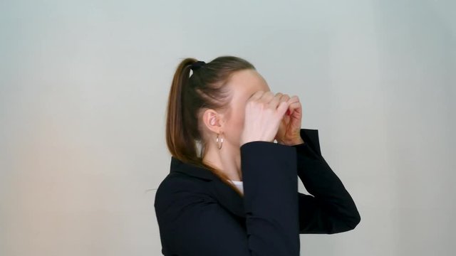 Pretty business woman hold bitcoin coin. Testing by her tooth.