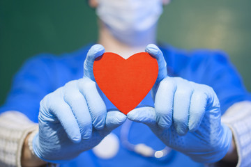 Doctor offers red heart. Healthcare Hospital Patient Care concept.