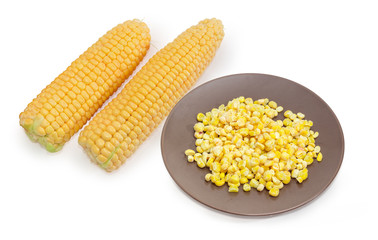 Frozen sweet corn kernels on dish against of fresh corn