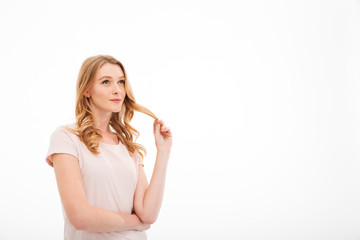 Cute young thoughtful lady standing isolated