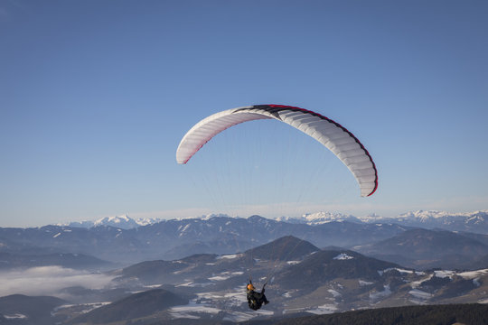 paragliding from mountain schoeckl in styria, austria. in the background mountain range hochschwab