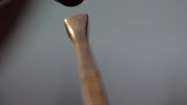 A close shot of a ice pick getting hammered