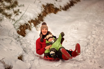 Fototapeta na wymiar Mom and child riding snow