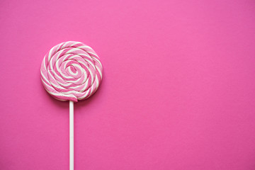 Pink lollipop on colorful background, Copy space for text. Brithday greeting card concept..