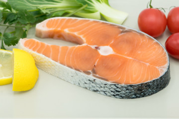 raw salmon steak with vegetable on plate, food and vegetable concept