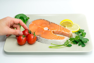 raw salmon steak with vegetable on plate, food and vegetable concept