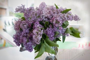 A bouquet of lilacs in front of light background