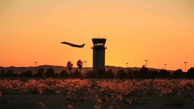 Plane Takes Off At Sunset By Air Traffic Tower At Hollywood Burbank Airport