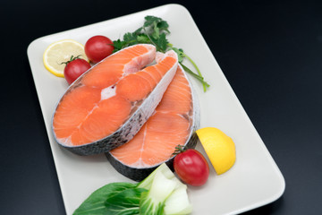 raw salmon steak with vegetable on plate, food and vegetable concept