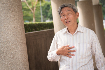 hand of senior old man holding acid reflux, esophagus cancer chest