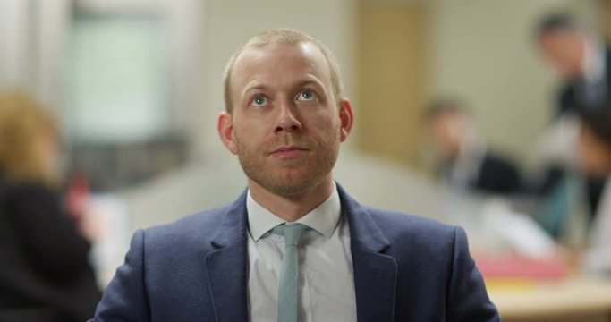 4K Corporate businessman looking very bored during video conference call in the office, seen from webcam's pov