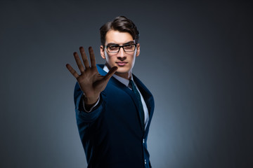 Businessman pressing virtual buttons on gray background