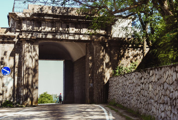 Baidar Gate in the Crimea, the Crimean cultural heritage, a monument, a bicyclist stands near the Baidar Gate.