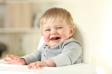 Fototapeta na wymiar Joyful baby with his first teeth looking at you
