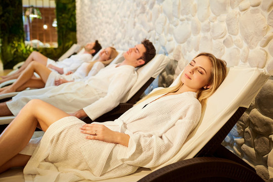 People In Bathrobes Are Resting In The Spa Salon. Friends Relax On Weekends.