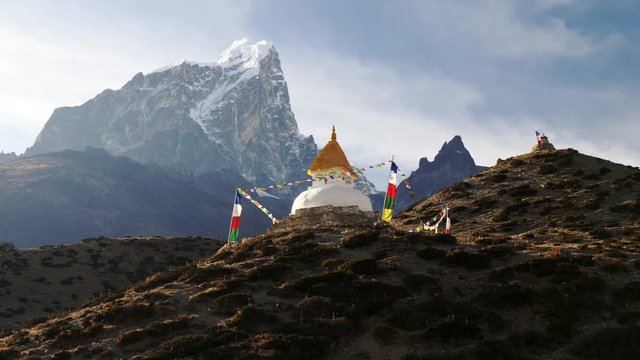 Steadicam shot of stupa with prayer flags on track to the base camp of Everest in the Himalayas, Nepal.