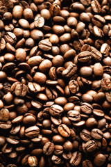 Roasted coffee beans backgound, copy space, top view. Cappuccino, dark espresso, aroma black caffeine drink, ingredient for coffee beverage.