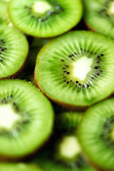 Fresh organic kiwi fruit sliced. Food frame with copy space for your text. Banner. Green kiwi circles background