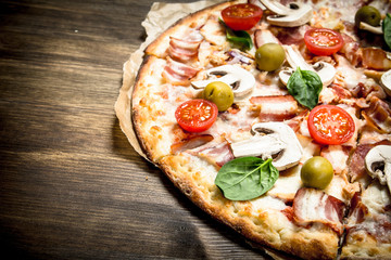 Fresh pizza. On wooden table.