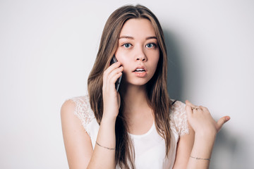 Young woman talking on phone in office