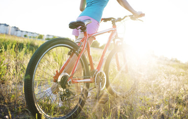 Fototapeta na wymiar Young girl with a sports bike in the sunlight