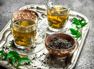 Fresh green tea on a steel tray.