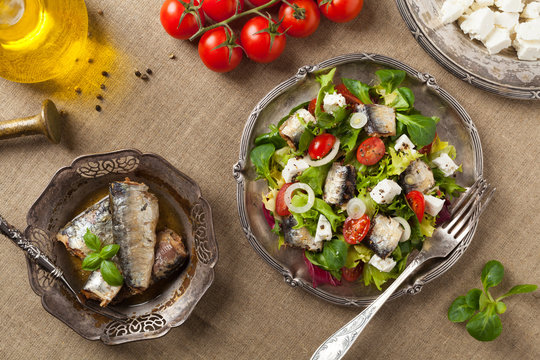 A delicious salad with sardines and feta cheese.