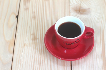 Red coffee cup on wood plate , valentine day concept.