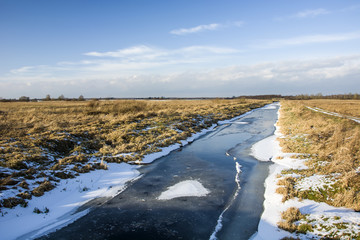 Floe on the river, meadows and blue sky