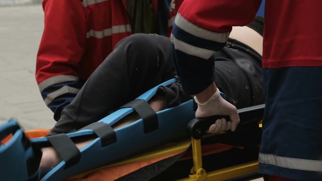 Medics taking injured person stretcher to X-ray room traumatology, leg problem