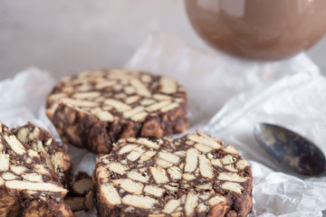 Pieces of chocolate cake from cookies and cocoa with marshmallow on bakery paper