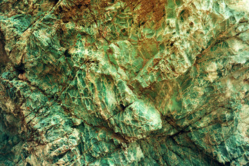 Close-up is a beautiful rock structure in a yellowish green tone. Background image