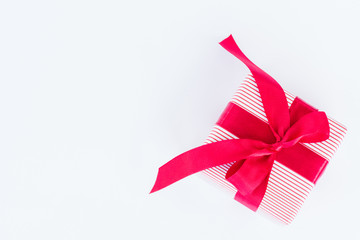 A gift box with red ribbon on white background.. Holidays, present, christmas, and happiness concept.